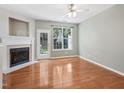 Bright living room with hardwood floors, fireplace, and large windows offering natural light at 111 Grey Elm Trl, Durham, NC 27713