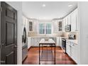 Bright kitchen featuring white cabinets, stainless steel appliances, and a stylish island at 112 Homegate Cir, Apex, NC 27502