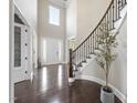 Spacious foyer with a soaring ceiling, hardwood floors, and a view of the staircase at 113 Amberwing Ct, Holly Springs, NC 27540