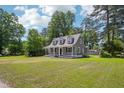 Inviting home with a spacious front yard, a classic covered porch, and lush green surroundings at 1331 Sunset Ave, Rocky Mount, NC 27804