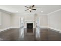 Spacious living room featuring a fireplace, a ceiling fan, and pristine hardwood floors at 1331 Sunset Ave, Rocky Mount, NC 27804