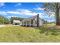 Charming home with a well-manicured lawn and detached garage at 1347 Crocker Rd, Smithfield, NC 27577