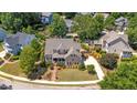 Beautiful aerial view of home with manicured lawn, mature landscaping, and circular driveway at 1437 Chelton Oaks Pl, Raleigh, NC 27614