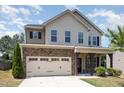 Charming two-story home with stone accents, covered porch and two car garage at 163 Davelyn Ct, Garner, NC 27529