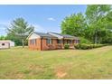Well-maintained brick home with manicured landscaping at 1647 Turner Rd, Mebane, NC 27302