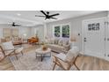 Bright living room with hardwood floors, stylish furniture, a large window, and ceiling fan at 1732 Green Pace Rd, Zebulon, NC 27597