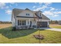 Attractive home with a gray garage door, stone accents, and a freshly seeded front yard at 175 Trescott St, Smithfield, NC 27577