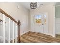 Bright foyer with beautiful front door, hardwood floors, and staircase at 175 Trescott St, Smithfield, NC 27577