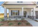 Inviting front porch with stone accents and freshly seeded front yard, offering curb appeal at 175 Trescott St, Smithfield, NC 27577