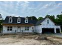 Exterior of a new home build with two-car garage and black roof at 196 Cozy Brook Ct, Clayton, NC 27520