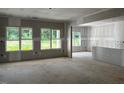 Spacious living room featuring multiple windows bringing natural light and unfinished walls at 196 Cozy Brook Ct, Clayton, NC 27520