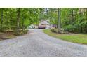 Charming two-story home featuring a long gravel driveway and mature trees at 196 Tara Ln, Timberlake, NC 27583