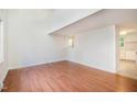 Bright living room with hardwood floors and a partial view of the kitchen at 2027 Jefferson Dr, Hillsborough, NC 27278