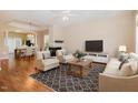 Inviting living room with hardwood floors, fireplace, and large windows for ample natural light, leading into dining area at 209 Mccarthy Dr, Clayton, NC 27527