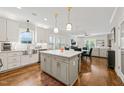 Modern kitchen with island, white cabinets, stainless appliances, and open to the living area at 2210 Bedford Ave, Raleigh, NC 27607