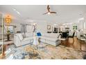 Bright living room with modern sofa, decorative rug, and seamless transition to kitchen at 2210 Bedford Ave, Raleigh, NC 27607