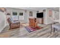 Cozy living room featuring two leather recliners, a large television, and stylish decor with gray vinyl floors at 2501 Ferrell Rd, Durham, NC 27704