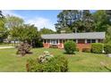 Inviting home exterior with a well-maintained lawn and colorful flower beds adding curb appeal at 2910 Dove Ln, Raleigh, NC 27604