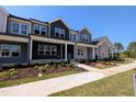 Inviting townhome exterior with modern architectural details, and meticulously manicured front yard at 2917 Alyssa Ct, Knightdale, NC 27604