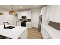Well-lit kitchen with an island, stainless steel appliances, and white cabinetry at 2917 Alyssa Ct, Knightdale, NC 27604