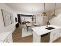Open-concept living and dining area with modern lighting and ample natural light at 2917 Alyssa Ct, Knightdale, NC 27604
