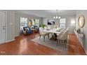 Inviting dining room featuring hardwood floors, modern furnishings, and plenty of natural light at 3069 Buttonwood Ln, Clayton, NC 27520