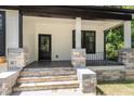 Charming front porch with stone accents, dark door, and stylish columns at 310 W Club Blvd, Durham, NC 27704