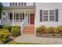 Inviting front porch with brick steps and walkway, complemented by blooming bushes at 3315 Swinford Ct, Raleigh, NC 27604