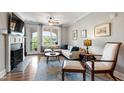 Comfortable living room with fireplace, French doors to balcony, and hardwood floors at 340 Allister Dr # 201, Raleigh, NC 27609