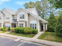 Inviting townhouse with stone accents, manicured landscaping, walkway, and convenient parking at 3601 Sugar Tree Pl, Durham, NC 27713