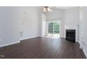 Bright living room with fireplace, wood floors, and sliding glass door to backyard at 3601 Sugar Tree Pl, Durham, NC 27713