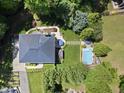 Aerial view of a home featuring a pool, manicured lawn, and lush landscaping at 3617 Carlow Ct, Raleigh, NC 27612