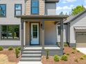 Inviting front porch features stylish columns and neutral brickwork, adding a cozy touch to the entrance at 380 Pilot Ridge Rd, Zebulon, NC 27597