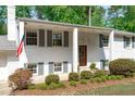 Welcoming front entry with white columns, gray shutters, and a classic wood door at 4109 Huckleberry Dr, Raleigh, NC 27612