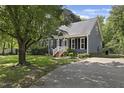 A well-maintained home with a driveway, manicured lawn, and inviting front porch at 413 Redpath Dr, Garner, NC 27529