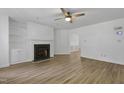 A spacious living room featuring a fireplace with built-ins and wood grain laminate floors at 413 Redpath Dr, Garner, NC 27529