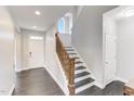 Inviting entryway featuring hardwood floors, a staircase with wood railing, and ample natural light at 4613 Jersey Pine Dr, Rolesville, NC 27571