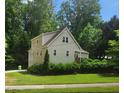 Charming two-story home with light siding, mature trees, and a well-manicured lawn at 4900 North Hills Dr, Raleigh, NC 27612