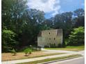 Two-story home with a rear entry garage and a well-maintained lawn and garden at 4900 North Hills Dr, Raleigh, NC 27612