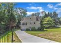 Exterior shot of the back of the house showing a driveway leading to a garage and an entrance at 4900 North Hills Dr, Raleigh, NC 27612