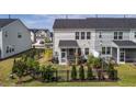 Well-maintained backyard with black metal fence, lawn, garden, and screened-in porch at 5054 Kota St, Raleigh, NC 27610