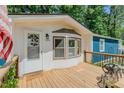 Close-up of front porch, with decorative welcome mat, sidelight and charming features at 5100 Yale Ct, Graham, NC 27253