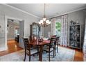 Elegant dining room featuring hardwood floors, a stylish chandelier, and plenty of natural light at 518 S Main St, Wake Forest, NC 27587