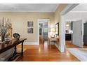 Inviting hallway with gleaming hardwood floors and easy access to multiple rooms at 518 S Main St, Wake Forest, NC 27587