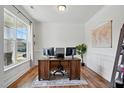 Bright home office featuring hardwood floors, large window, and a workspace at 521 Glenwyck Ct, Fuquay Varina, NC 27526