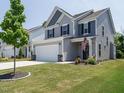 Charming two-story home with a well-manicured lawn and an attached two-car garage at 555 Whitley Ridge Dr, Clayton, NC 27527