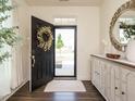 Welcoming foyer featuring wood floors, decorative wreath, and a stylish accent table at 555 Whitley Ridge Dr, Clayton, NC 27527