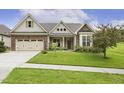 Single Gathering home featuring brick accents, a well-manicured lawn, and a driveway at 624 Meadowgrass Ln, Wake Forest, NC 27587