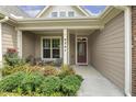 Inviting front porch with chairs, decorative plants, and a stylish front door at 624 Meadowgrass Ln, Wake Forest, NC 27587