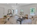 Inviting living room with a ceiling fan, natural light, and access to the staircase at 801 N Elm St, Durham, NC 27701